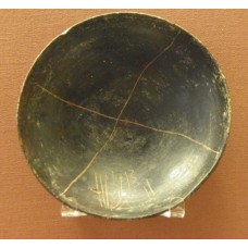 Black painted dish, with graffiti design, cross, solar cross
